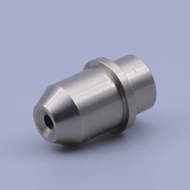 Silver machined metal component with a tapered tip and central hole on a light blue background