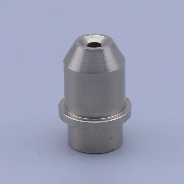 A machined metal component with a central hole and a stepped base