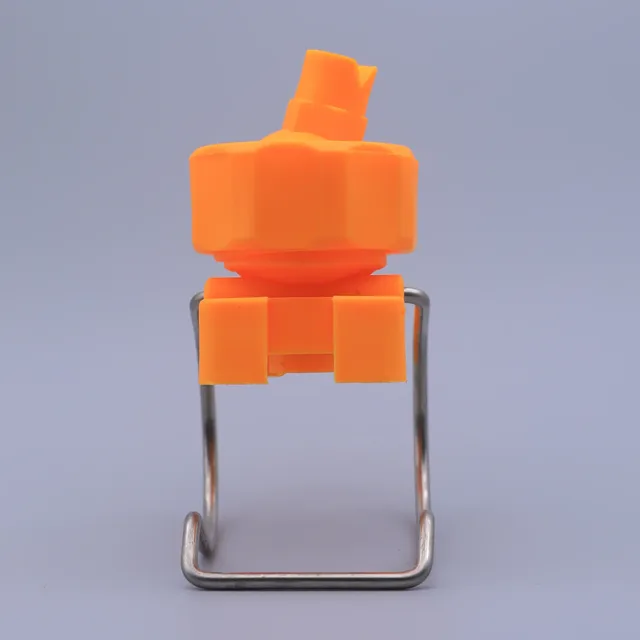 Orange plastic cap with metal wire clip on a gray background