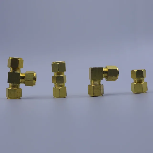 Four brass compression fittings arranged in a row on a gray background