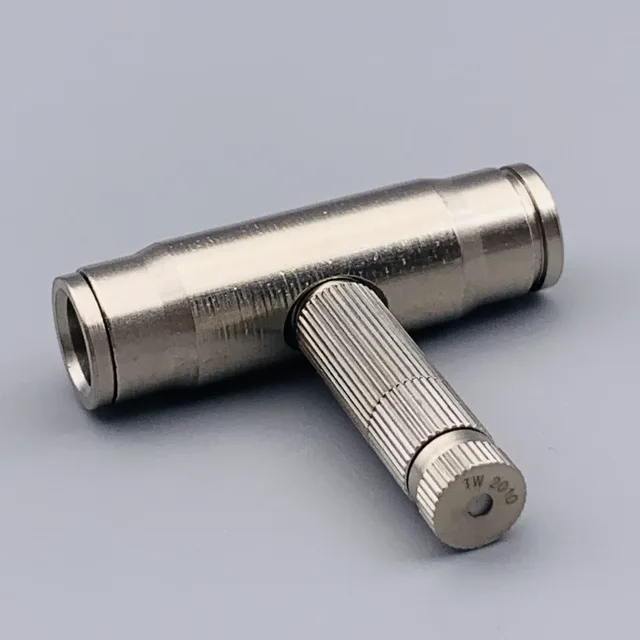 Silver metal T-shaped connector with knurled grip on a gray background