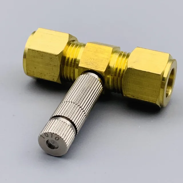 Brass T-fitting with a knurled silver metal component inserted into the center port