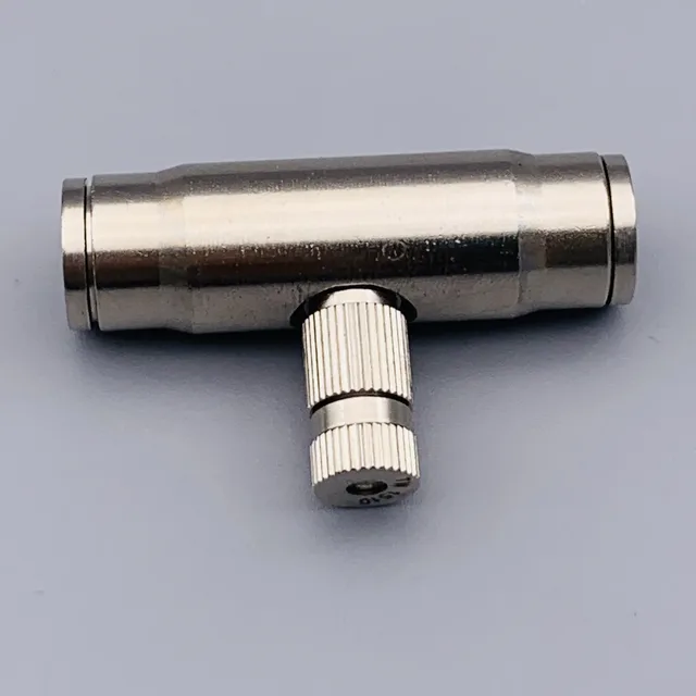 Silver metallic T-shaped coaxial RF splitter with knurled connectors on a plain gray background