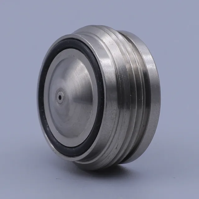 Close-up of a cylindrical stainless steel mechanical component featuring a black rubber seal ring and threaded grooves