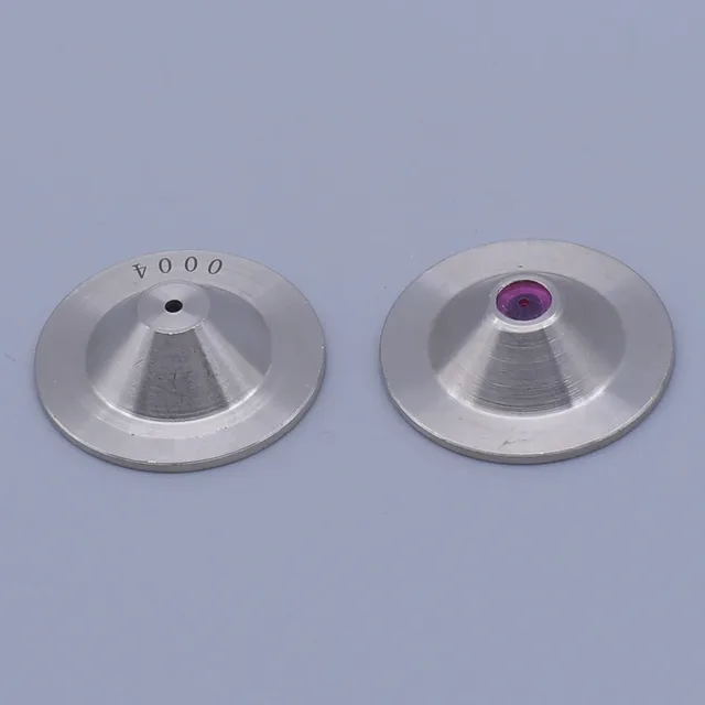 Two silver conical metal discs with central holes, one featuring a purple gem insert