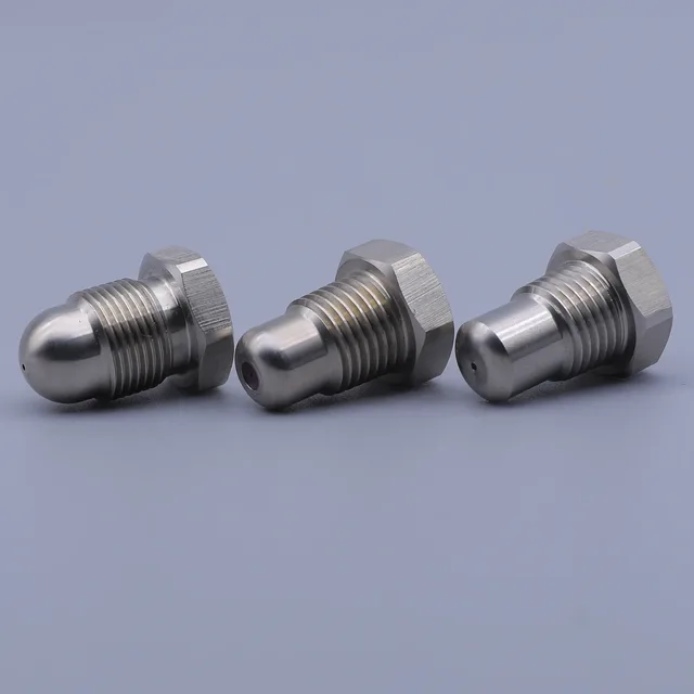 Three stainless steel spray nozzles with hexagonal bases arranged on a light grey background