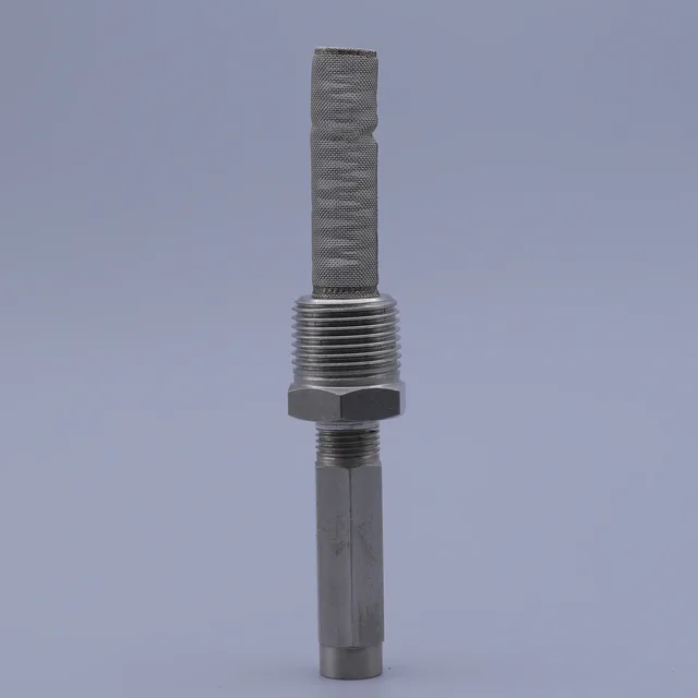 Vertical close-up of a metallic sensor with a knurled mesh tip and hex nut against a grey background