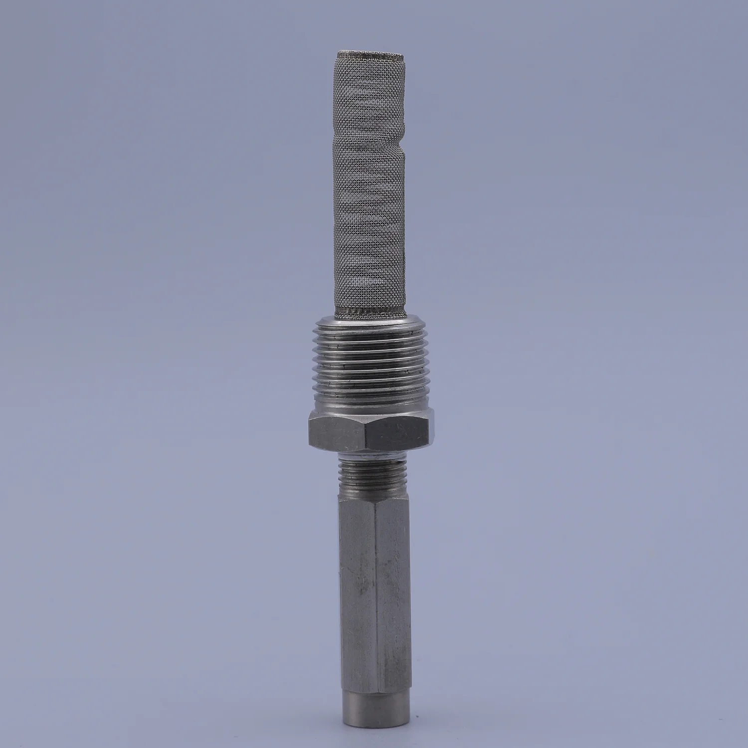Vertical close-up of a metallic sensor with a knurled mesh tip and hex nut against a grey background