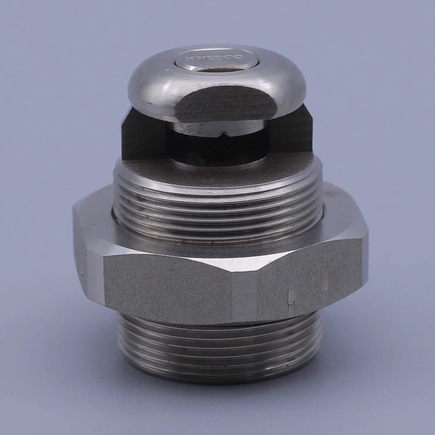 Stainless steel threaded industrial fitting with a hexagonal body and a domed top