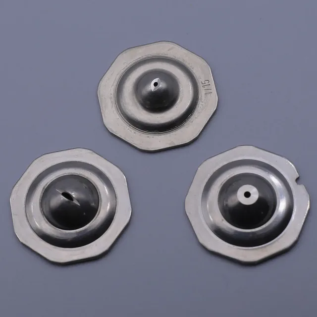 Three metallic industrial components with octagonal flanges and central domes, each featuring a small orifice