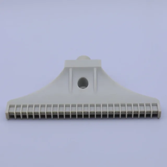 Beige plastic squeegee head with ribbed edge and center hole on plain background