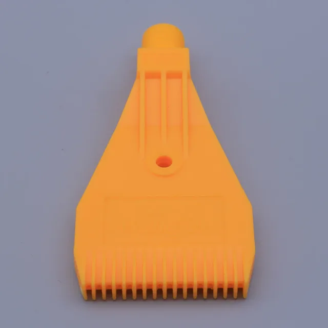 Orange plastic nozzle with a wide, ribbed edge and a top connector against a plain grey background