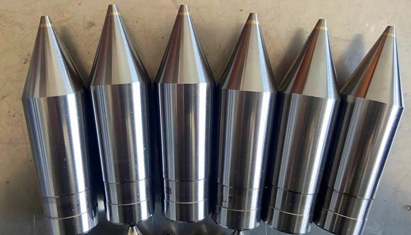 Row of SGT tungsten carbide extrusion tips for cable insulation lines