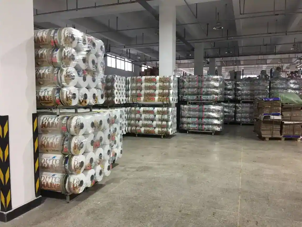 Warehouse stacked with bale net wrap rolls on pallets