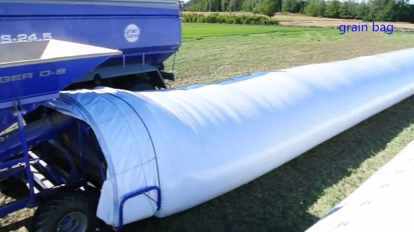 White silage bag being filled on a farm yard