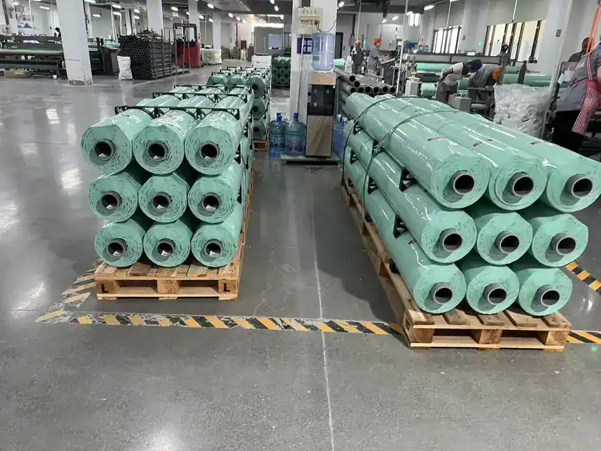 Green silage film rolls stacked in the production hall