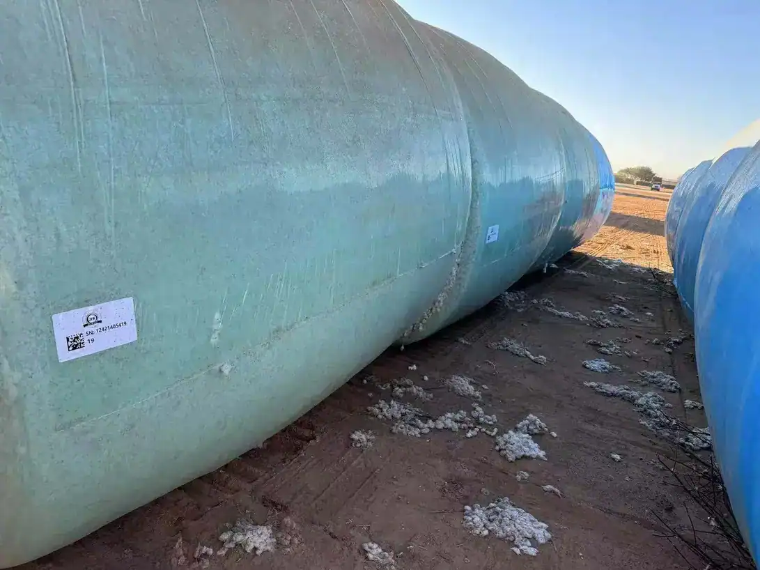 Round cotton module wrapped in TS-WRAP film in a harvested field