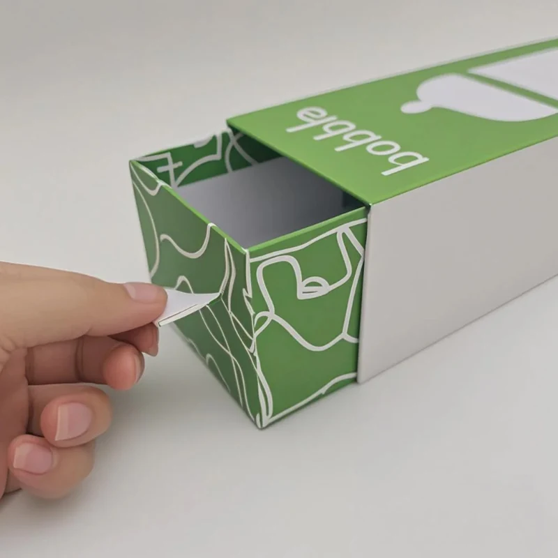 Sliding drawer gift box for baby products shown half open