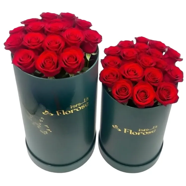 Round flower boxes filled with preserved red roses
