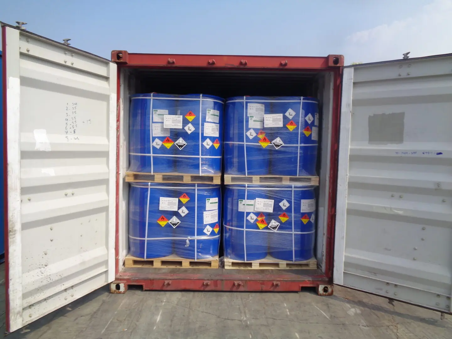 Palletised chemical drums braced inside an export container