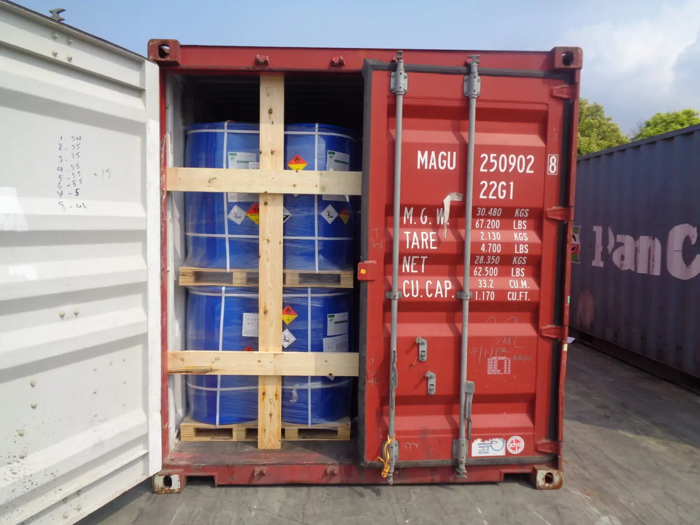 Solvent drums palletised and strapped for export inside a container