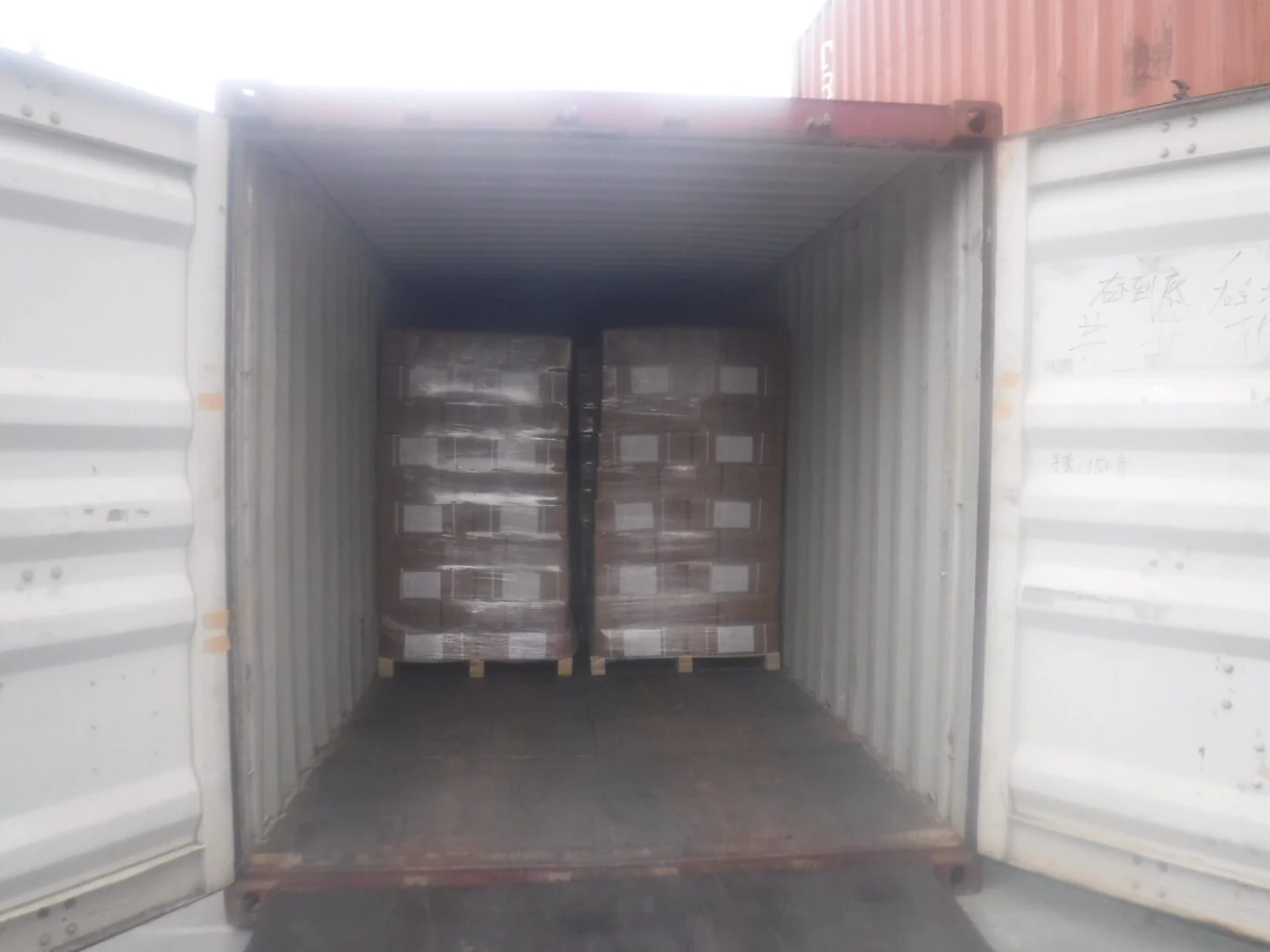 Cased and palletised goods braced inside an export container