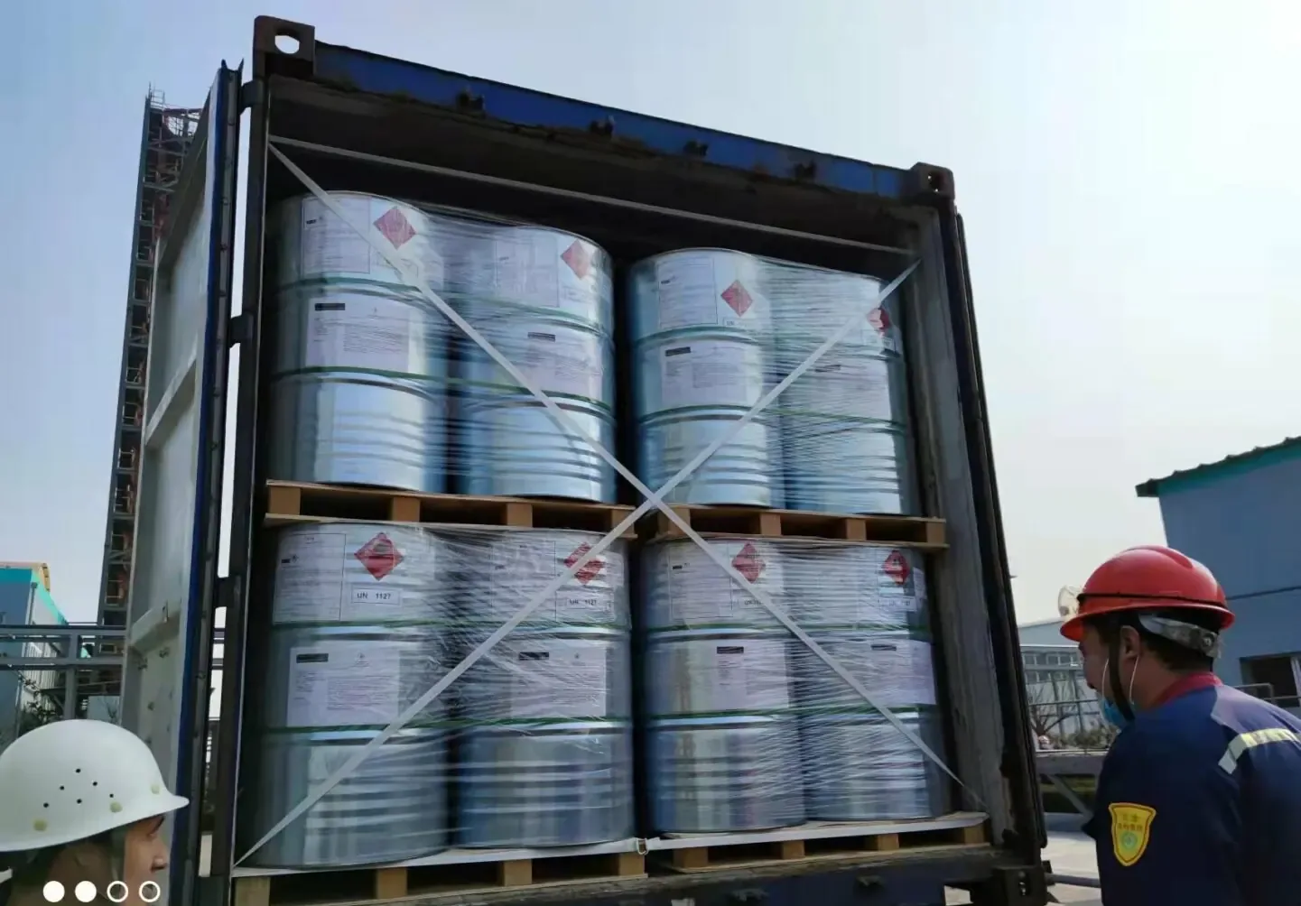 Blue steel drums of plasticizer feedstock stacked on pallets for export