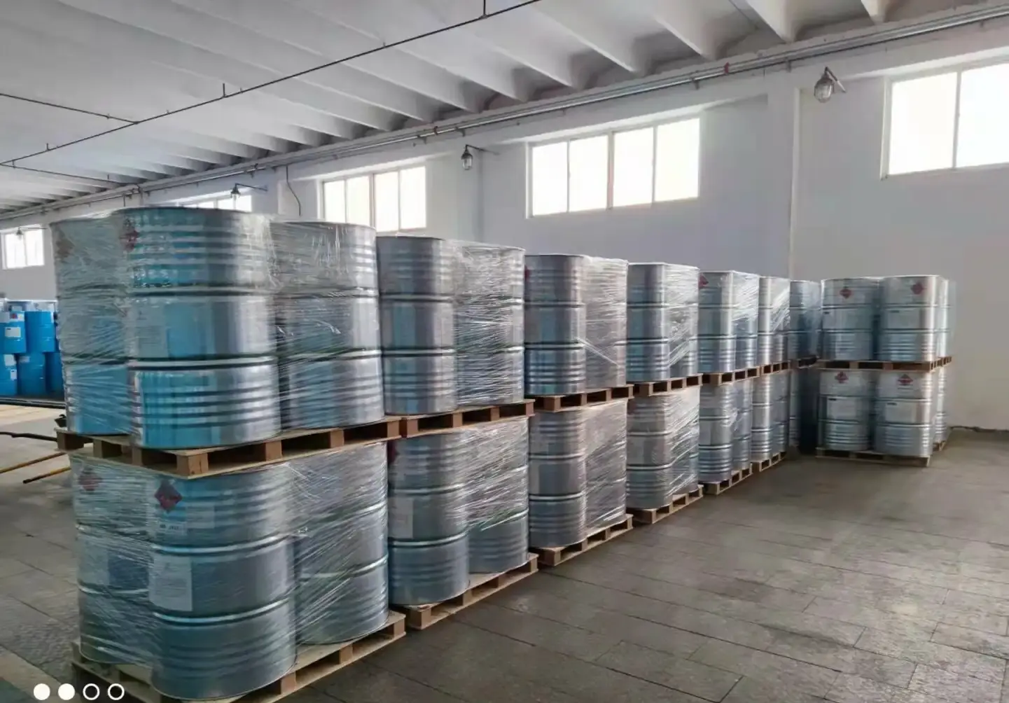Palletised blue steel drums of solvent grade chemicals loaded in an export container