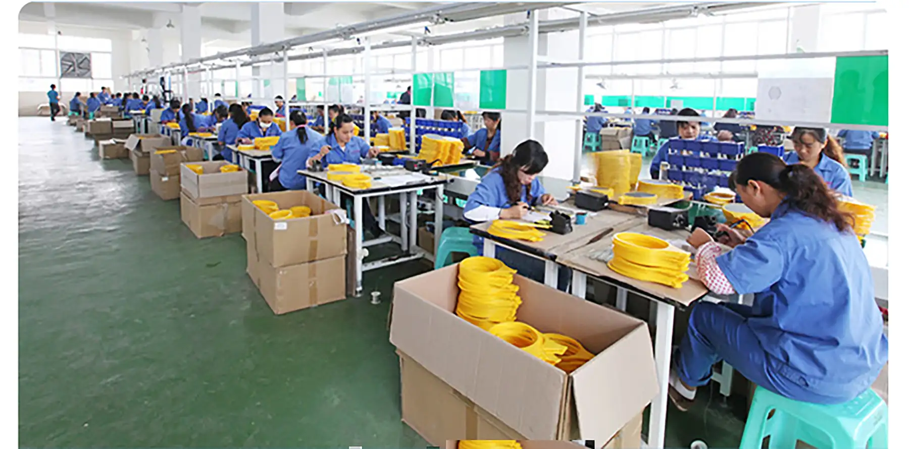DANQ assembly line in Yiwu with workers assembling yellow mosquito swatter heads