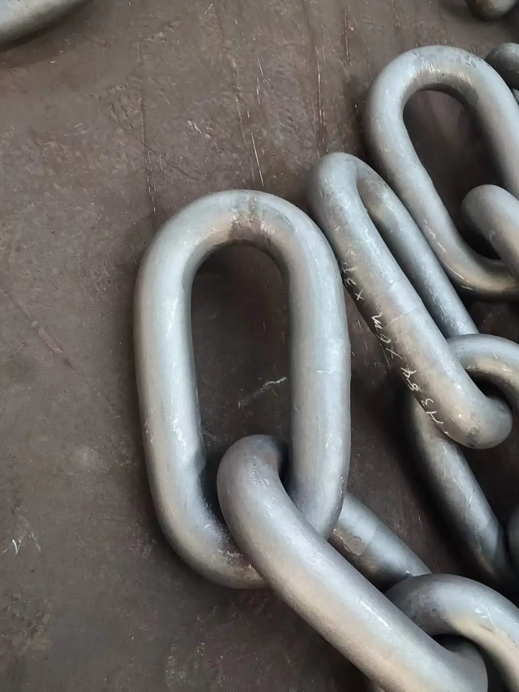 Bituminous painted chafe chain before shipment