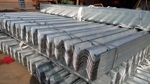 Steel coil being fed into the W-beam roll forming machine at Hongda factory