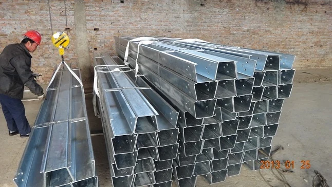 Bundled open box beam sections prepared for container shipment