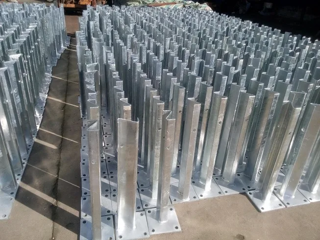 Z-shaped guardrail post mounted on a concrete base with steel plate and bolts