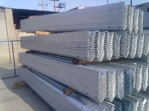 Finished W-beam sections being inspected before bundling for shipment