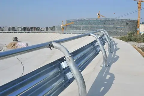Close view of the two-corrugation W-beam profile showing splice hole pattern