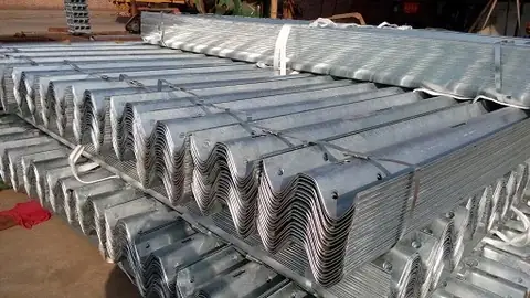 Steel coil being fed into the W-beam roll forming machine at Hongda factory