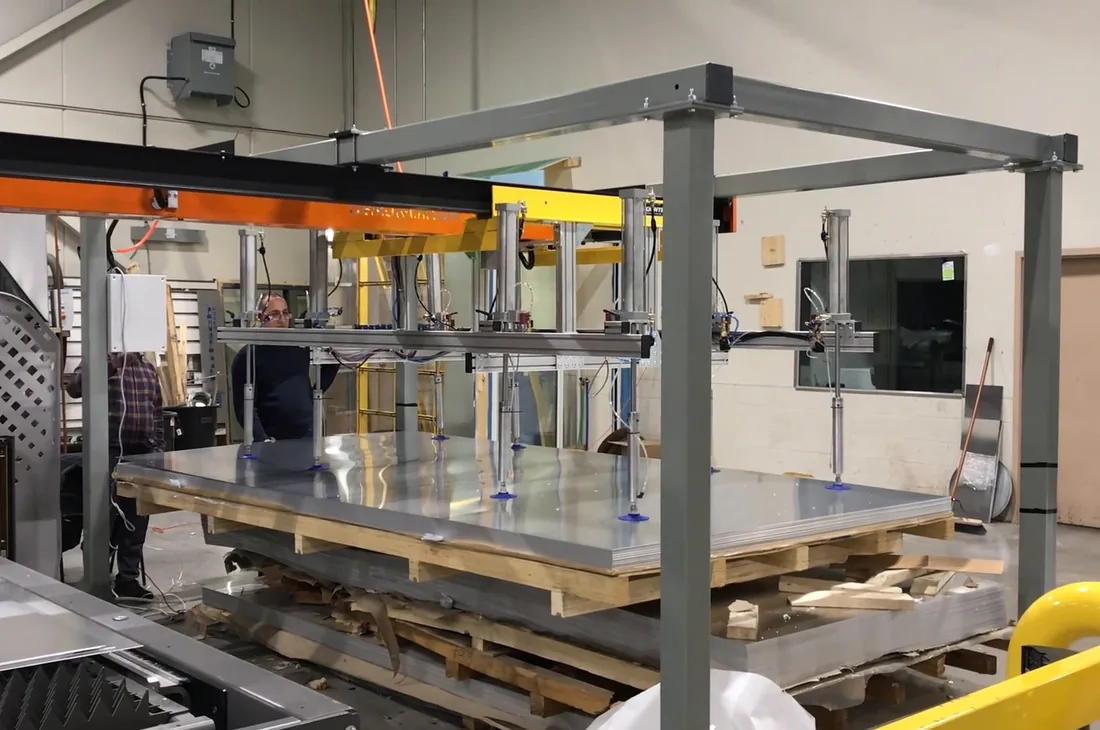 De-stacker table holding a pallet of aluminium blanks beside the gantry