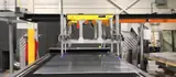 Wide view of a Delkotech sheet metal automation cell with conveyor infeed