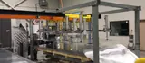 Vacuum gantry lifting a large aluminium sheet clear of the stack
