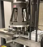 Multi-spindle press head working over a stack of aluminium panels