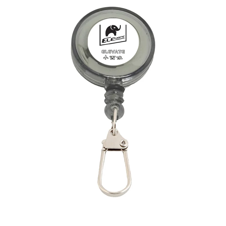Round retractable fishing zinger with plastic hook and 60 cm cord, mounted on a black background