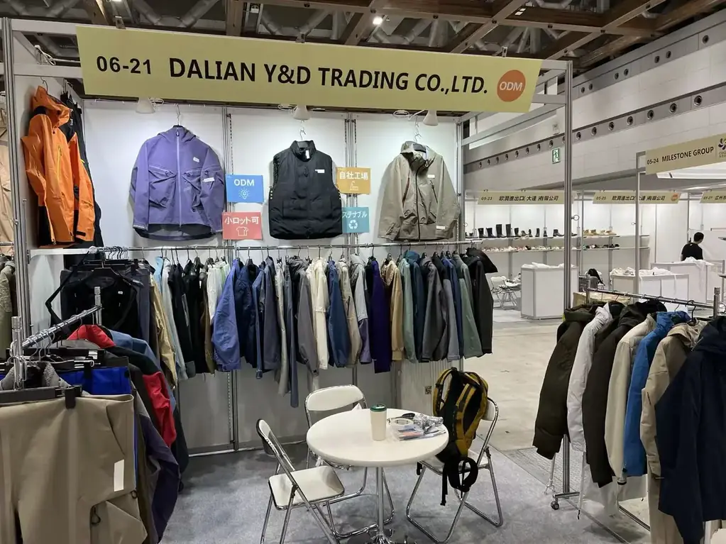 Outerwear samples hung across the booth wall at an apparel OEM fair