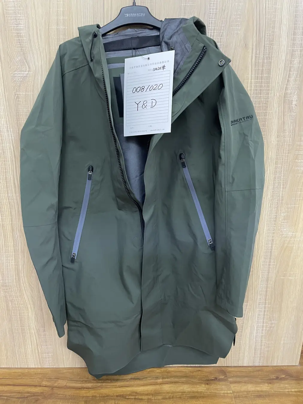 YD211 hooded tech raincoat in 3L film construction with taped seams and magnetic accessories