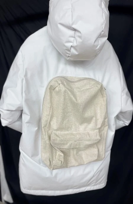 Close-up of the down jacket's double layer downbag construction and zip closure