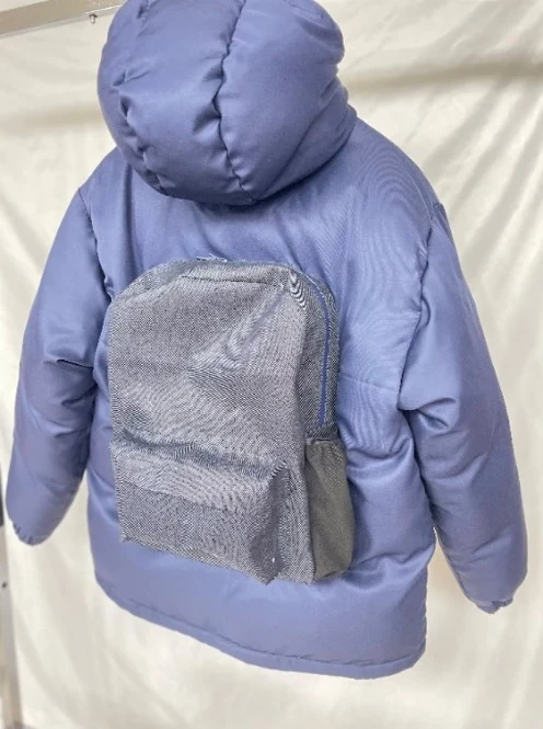 Close-up of the double-layer downbag with cotton shell, PU mid-layer, and poly lining