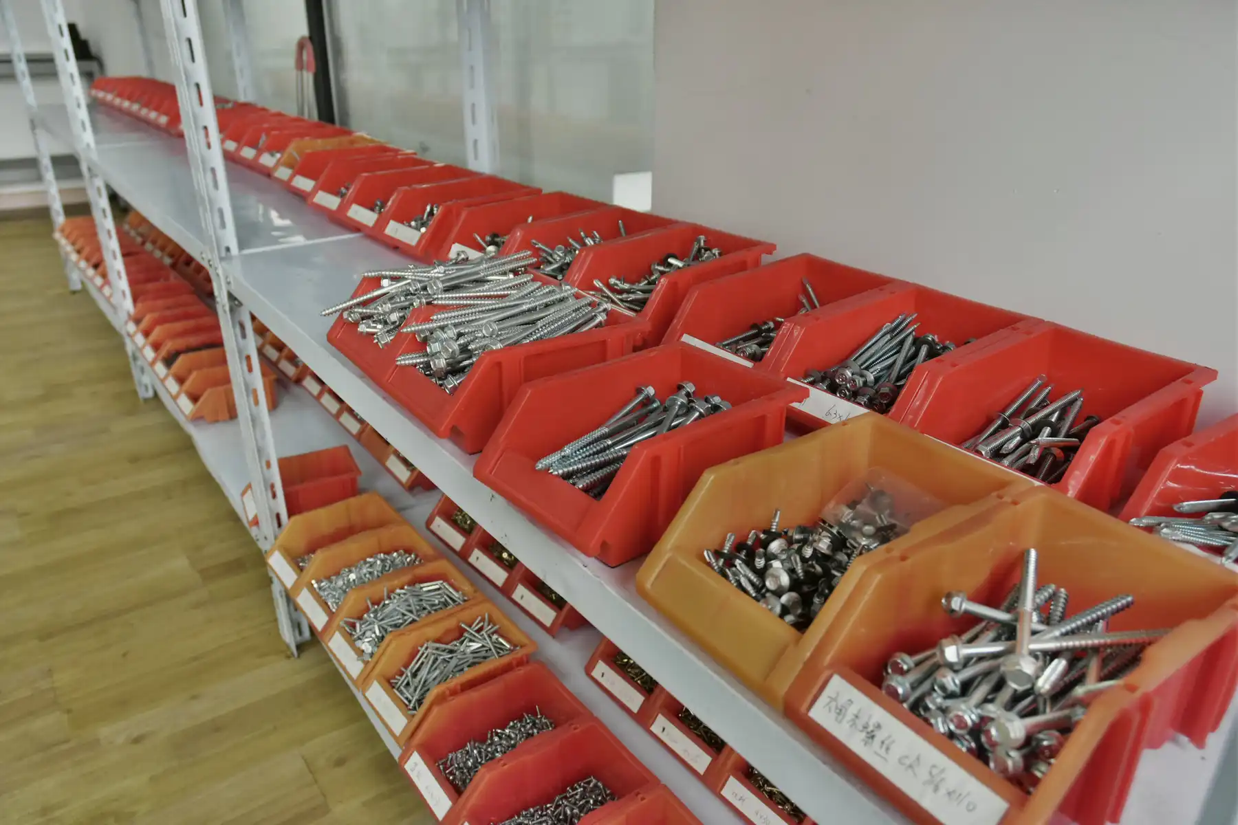 Sorted screw samples in inspection trays at the quality control station