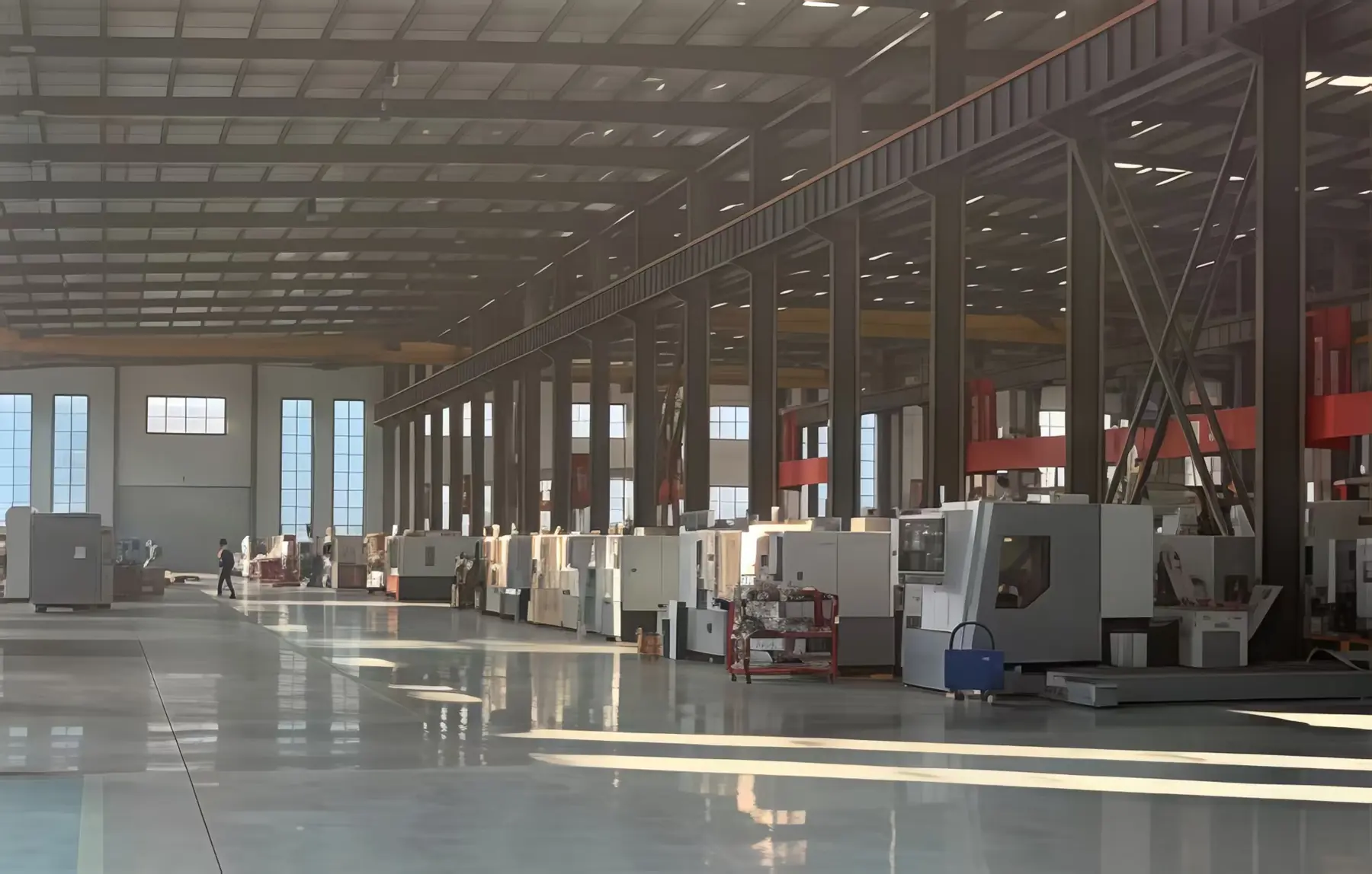 Wide view of the production hall with overhead lighting and clear working aisles