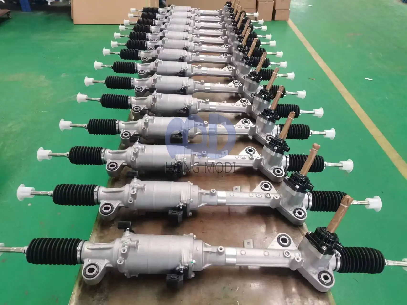 Long row of finished electric power steering racks laid out ready for packing