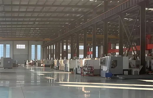 Wide view of the production hall with overhead lighting and clear working aisles