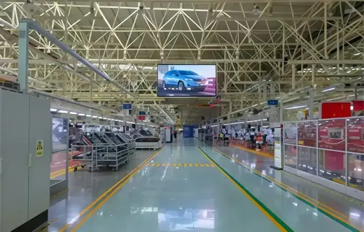 Production line inside the plant with work stations along the aisle